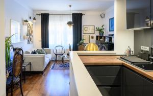 a kitchen and a living room with a couch at Designer Two-Bedroom Apartment in Split
