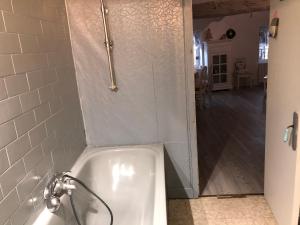 a white bath tub in a bathroom with a hallway at Le Nid du bois d'Oingt in Le Bois-dʼOingt +59 photos