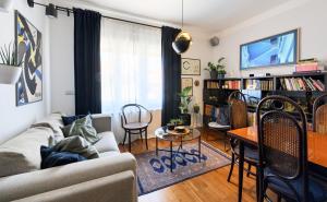 a living room with a couch and a table at Designer Two-Bedroom Apartment in Split