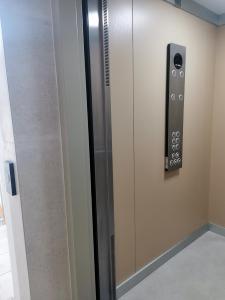 a elevator with a door with a control panel at Design Apartment near Gorica Park in Podgorica