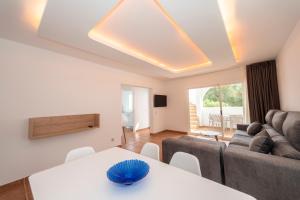 a living room with a couch and a table at Apartamentos Blanco Sol in Cala Vadella