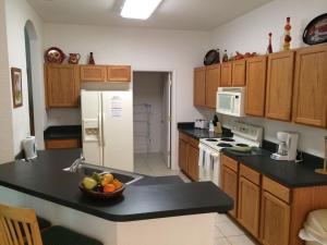 a kitchen with a bowl of fruit on a counter at 4 Bed 3 Bath 448 Birkdale, overlooks golf course, home in Davenport