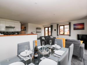 a living room with a table with wine glasses at Bluebell Lodge, Meadow view lodges in Burnham on Sea