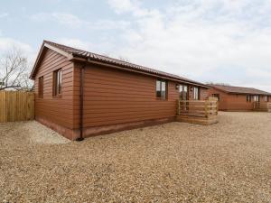 a house with a large yard in front of it at Bluebell Lodge, Meadow view lodges in Burnham on Sea