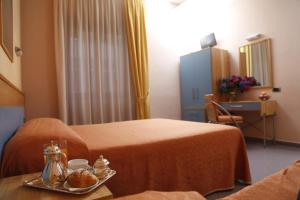 Postel nebo postele na pokoji v ubytování Hotel Diana