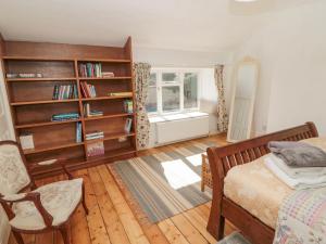 a bedroom with a bed and a book shelf at Ravens Heugh in Morpeth