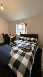 a bedroom with a black and white checkered bed at No.9 Cosy Private Studio in Moseley, Birmingham in Birmingham
