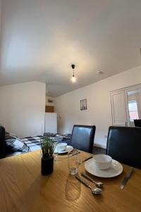 a dining room table with chairs and a wooden table at No.9 Cosy Private Studio in Moseley, Birmingham in Birmingham