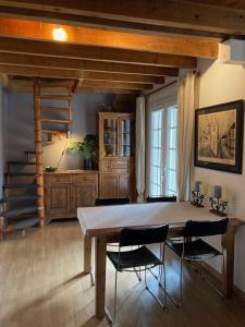 a dining room with a wooden table and chairs at Large Chalet Near Gorges du Verdon in La Bastide