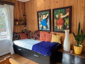 1 dormitorio con 1 cama con pinturas en la pared en Large Chalet Near Gorges du Verdon, en La Bastide