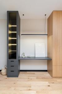 a kitchen with a shelf and a cabinet at Malila Premium Apartments Cracow Centre Wiślane Tarasy 2 0 in Krakow