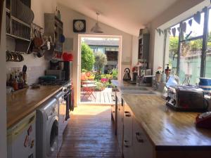 a kitchen with a sink and a stove top oven at Heart house fisherman’s cottage in Kent