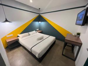 a bedroom with a bed with a colorful wall at Smile Hotel Cheras Sri Permaisuri in Kuala Lumpur +15 photos