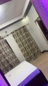 une pièce vide avec un lit et un mur dans l'établissement Hôtel Résidence Aïcha Tambacounda, à Tambacounda