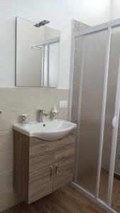 W łazience znajduje się umywalka oraz prysznic z lustrem. w obiekcie Scirocco e Maestrale w mieście Petrosino