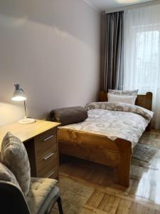 Un pat sau paturi într-o cameră la Apartman VALI1