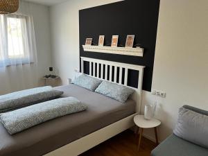 a bedroom with a bed with two pillows on it at FeWo Aurora am Bodensee in Friedrichshafen