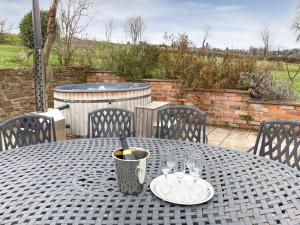 a table with a plate of wine glasses on it at The Hop Bind in Bromyard