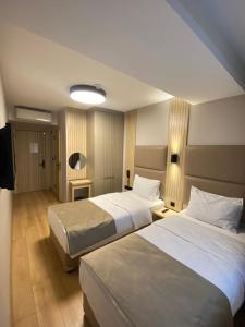 a hotel room with two beds and a television at Otel Yenikapı in Istanbul +9 photos