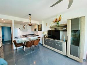 a kitchen with a table and chairs in a room at Mar Azul in La Manga del Mar Menor