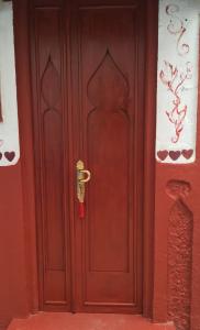 a wooden door with a lock on it at HATHOR ,Casa marroquí con dos terrazas en la Medina antigua , ideal parejas!! WIFI!! in Asilah