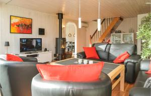 a living room with leather furniture and a television at Nice Home In Blvand With Kitchen in Ho