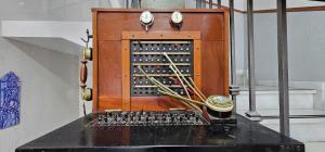 a wooden cabinet with a keyboard and a clock at Hostal Cuevas in Fuengirola