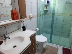 a bathroom with a sink and a shower and a toilet at casa no paraíso do Capri in São Francisco do Sul +39 photos