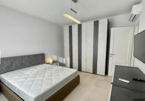 a bedroom with a bed and a television in it at Nature Apartment in Olbia