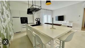 a kitchen with a table and chairs in a room at Nature Apartment in Olbia