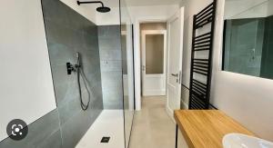 a bathroom with a glass shower and a sink at Nature Apartment in Olbia +14 photos