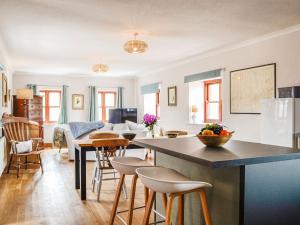 a kitchen and living room with a table and chairs at Low Moat in Canonbie