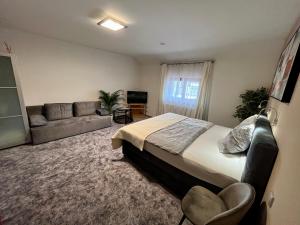ein Schlafzimmer mit einem großen Bett und einem Sofa in der Unterkunft Hotel Algar in Opava