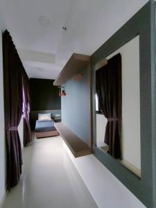 a room with a room with a bed and a mirror at Meridin Medini Sovo, Iskandar Puteri, Johor in Nusajaya