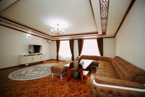 a living room with a couch and a television at FAYZ in Urganch