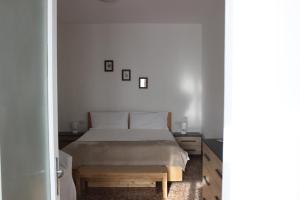 a bedroom with a bed and a wooden table at Casa Lia in Lesa