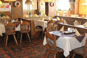 une salle à manger avec des tables et des chaises dans un restaurant dans l'établissement Pension Schwartzwirt, à Neusiedl am Steinfelde