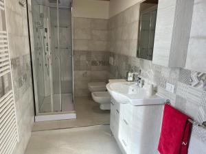 a bathroom with a toilet and a sink and a shower at Perla Top Floor Apartment in Sirmione +15 photos