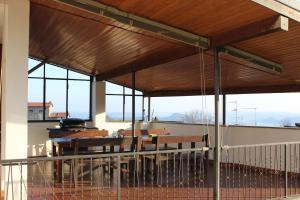 a patio with a table and chairs and windows at Casa Lia in Lesa