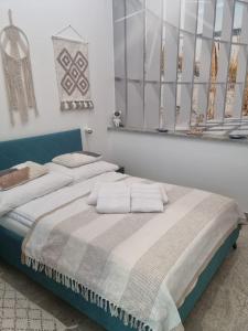 a bedroom with two beds with towels on them at Apartament BURSZTYNEK in Pobierowo