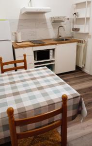 a kitchen with a table and a sink at Gemini camere e suites in Grosseto