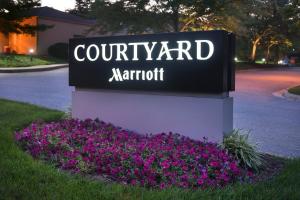 a sign for a court yard marriot with purple flowers at Courtyard By Marriott Baltimore Hunt Valley in Hunt Valley