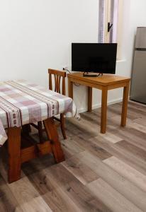 Habitación con escritorio y mesa con TV. en Gemini camere e suites, en Grosseto