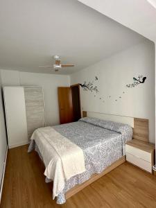 a bedroom with a bed in a white room at LA ISLA DE PEREZ GALDOS in Logroño