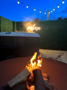 a fire pit with a sign that says love at Birch Cottage in Tenby