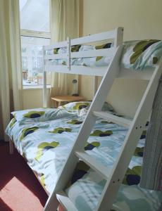two bunk beds in a room with a bed at Idyllic views over Loch Leven. Excellent location in Gateside