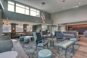 a lobby with chairs and tables and a waiting room at Residence Inn by Marriott Providence Lincoln in Lincoln