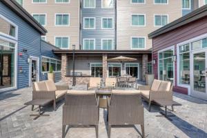 a patio with chairs and a table in front of a building at Residence Inn by Marriott Providence Lincoln in Lincoln