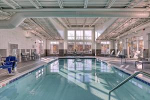 a large swimming pool with blue water at Residence Inn by Marriott Providence Lincoln in Lincoln
