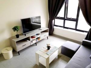 a living room with a couch and a tv at KA701-One Bedroom Apartment- Wifi -Netflix -Parking - Pool, 1002 in Cyberjaya